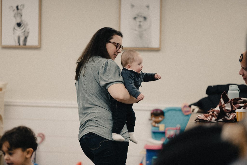 Woman holding baby at Church of the Valley in Chicopee, Pioneer Valley MA