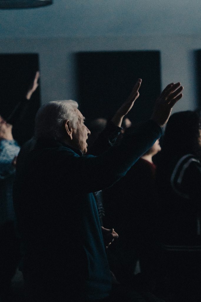 Man with hand raised praising at Church of the Valley in Chicopee, MA